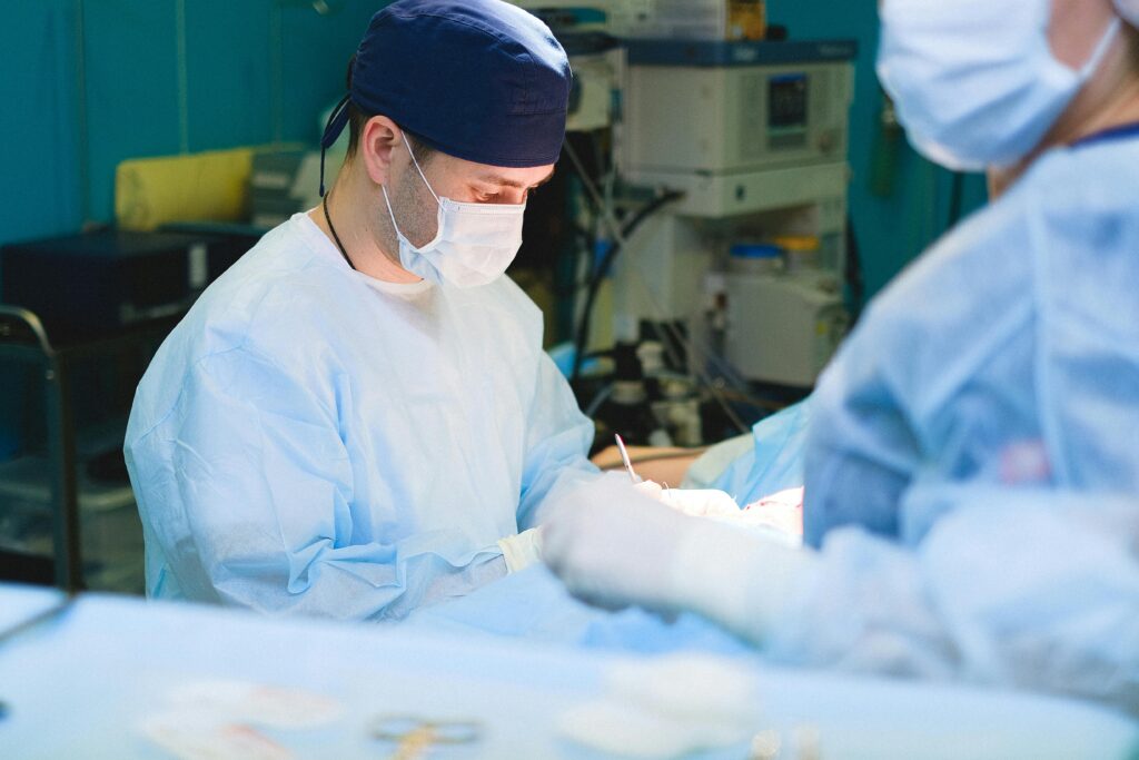 Team of surgeons performing a surgical procedure in a sterile operating room.